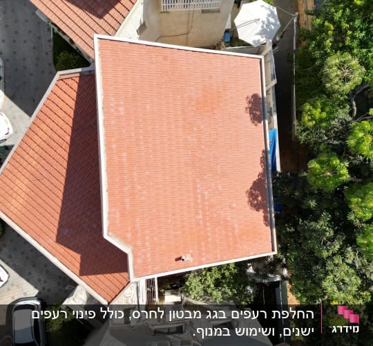 גג רעפים אדום עם עצים מסביב ומכוניות חונות